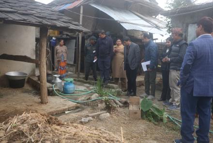 Staffs of PLGSP and province government in front of a house during monitoring of IP project